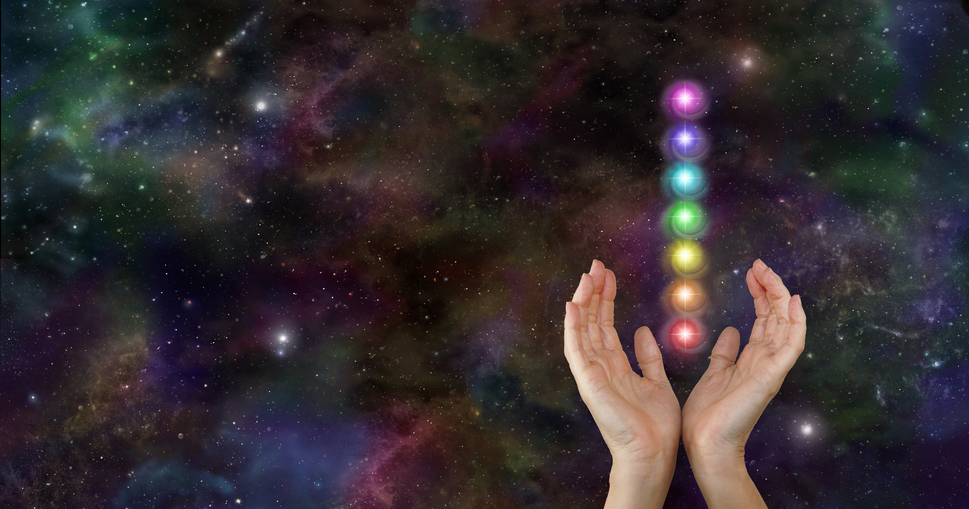 Hands cradling chakra light against a cosmic field